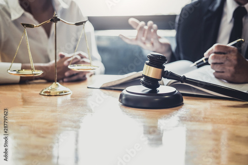 Male lawyer or Counselor working in courtroom have meeting with client are consultation with contract papers of real estate, Law and Legal services concept