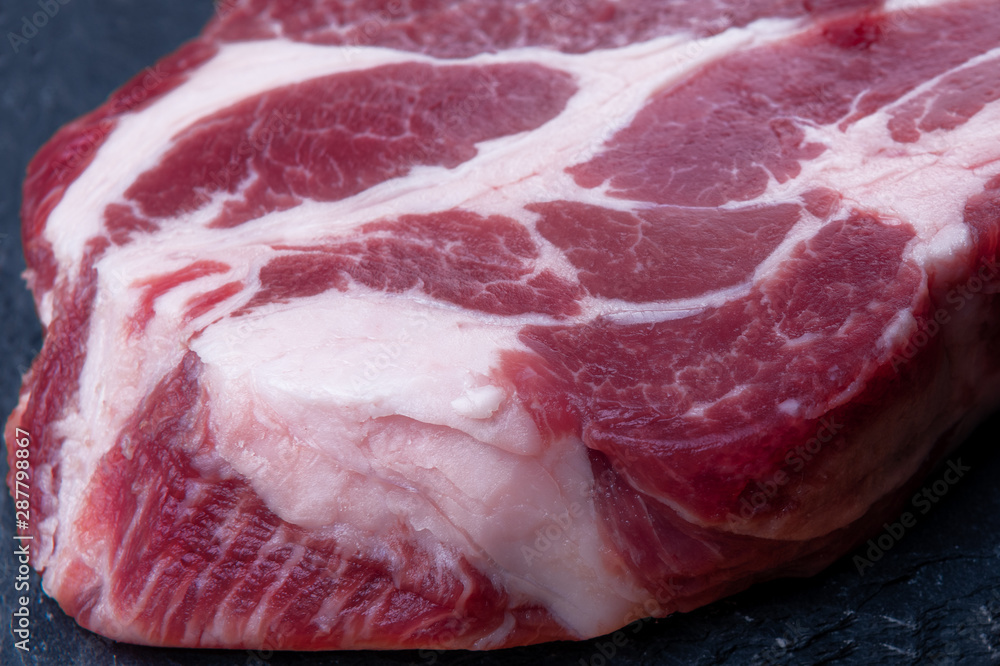 Close-up of a piece of meat with streaks of fat Close-up of a piece of meat with streaks of fat