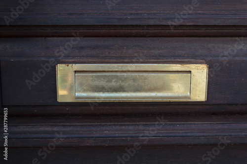 Letterbox on wooden door