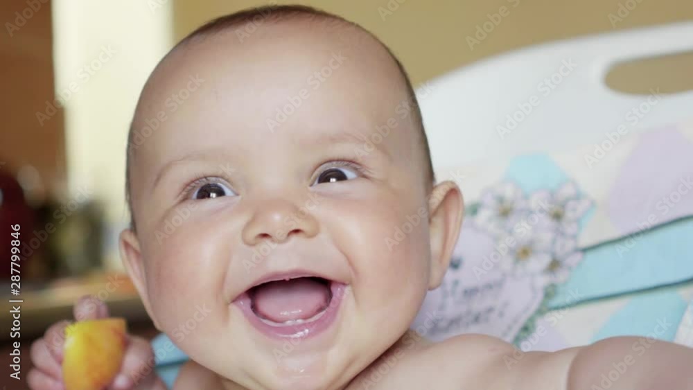 the baby eats an apple laughing, happy, delicious the baby eats an apple laughing, happy, delicious