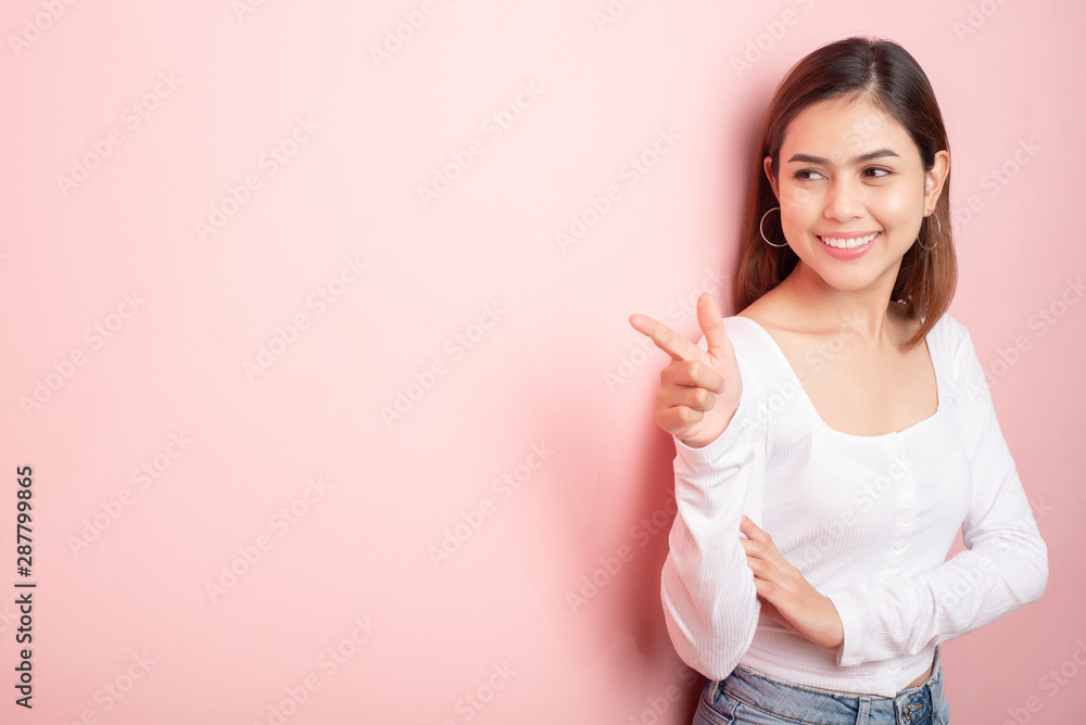 Beautiful university student is smiling on pink background Beautiful university student is smiling on pink background