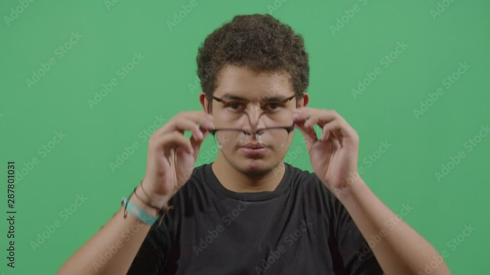 Young Boy Removing The Eye Glasses Like Done Reading Or No Need For Them Young Boy Removing The Eye Glasses Like Done Reading Or No Need For Them