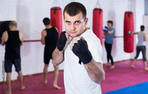 healthy sportsman in the boxing hall practicing boxing punches