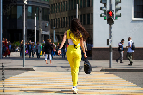 Portrait of a young beautiful brunette woman in yellow tracksuit photo