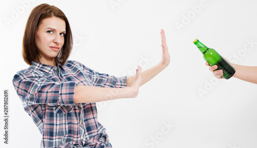 No bad habits: Woman rejaction alcohol drink isolated over white background, female addiction photo