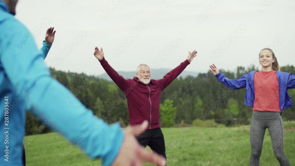 Large group of fit and active people doing exercise in nature. Large group of fit and active people doing exercise in nature.