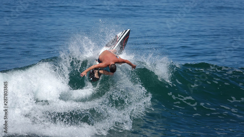 Canvas Print Unrecognizable male surfer on top of wave