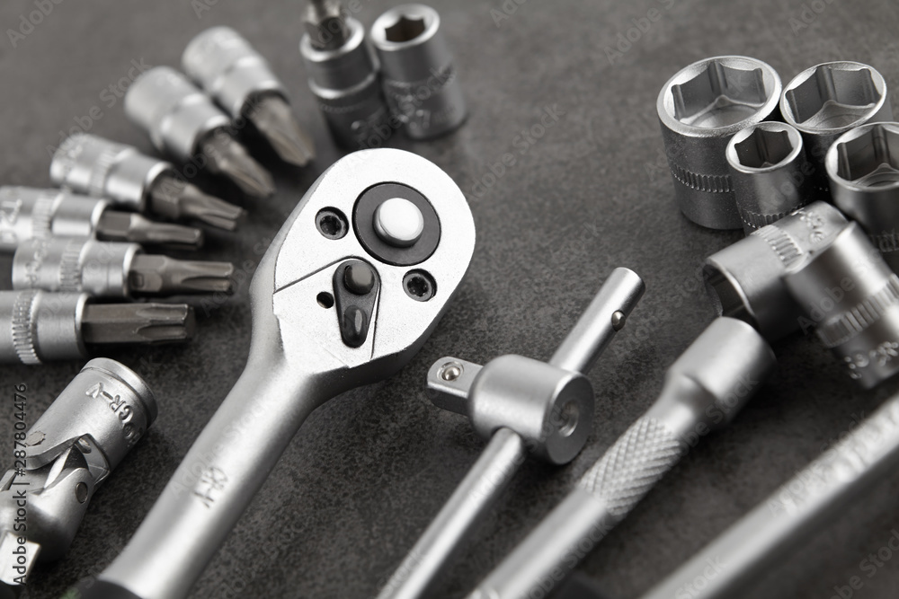 ratchet set with heads, different socket wrenches close-up on a dark stone background ratchet set with heads, different socket wrenches close-up on a dark stone background
