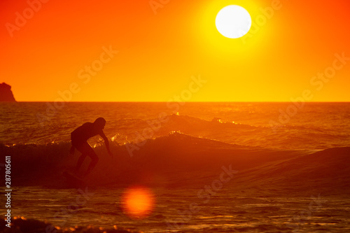 man surfing at sunset © Rojo