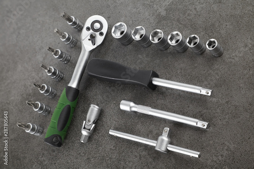 ratchet set with heads, different socket wrenches close-up on a dark stone background