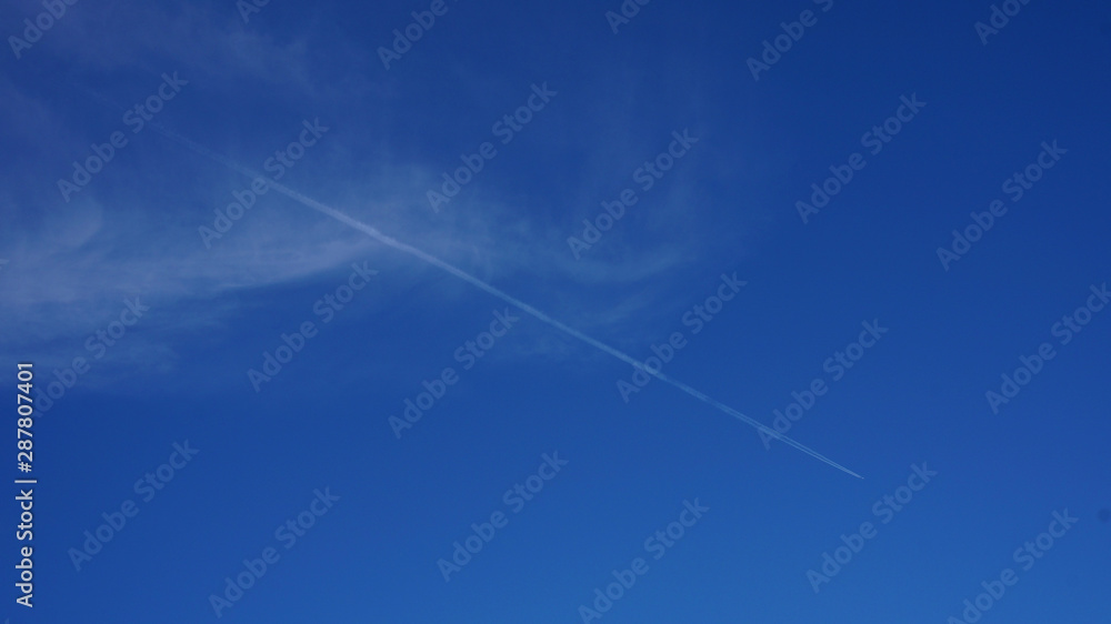 sky with light clouds and a trace of a flying plane sky with light clouds and a trace of a flying plane