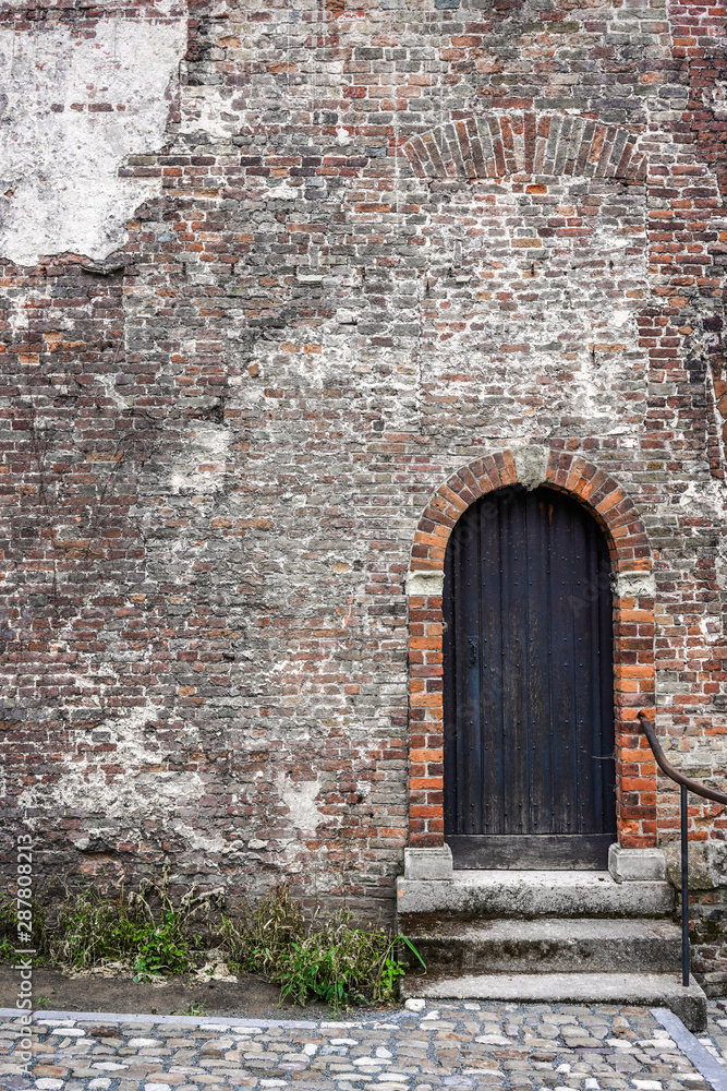 century old wooden door in stone wall ancient medieval castle entrance gate century old wooden door in stone wall ancient medieval castle entrance gate