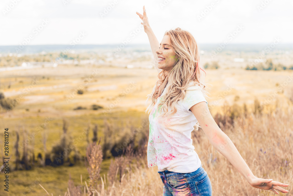 attractive woman in t-shirt with outstretched hands smiling and looking away