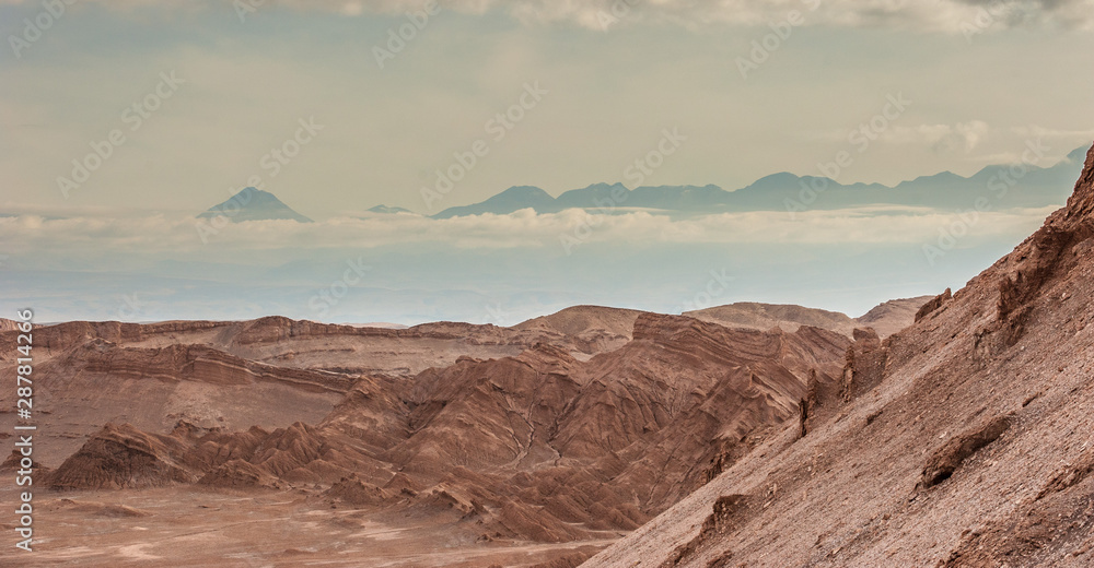 Sand formations, mountains, rocks at Valle de la Luna Moon Valley, San Pedro de Atacama Chile. Wide view of stunning sun rise on sand formation in world famous Atacama desert Chile. Salt formations Sand formations, mountains, rocks at Valle de la Luna Moon Valley, San Pedro de Atacama Chile. Wide view of stunning sun rise on sand formation in world famous Atacama desert Chile. Salt formations