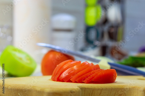 sliced tomatoes on a board in the kitchen