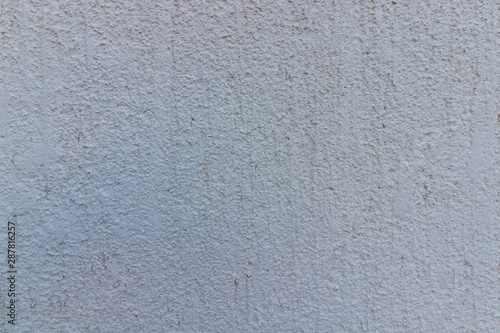white plaster facade roughly trimmed