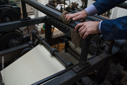 Close up of a human hands working on vintage printing press