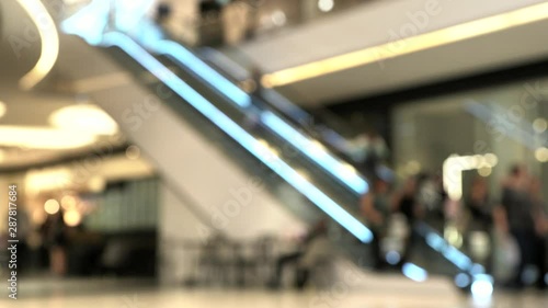 People in motion in escalator at the modern shopping mall. Blurred view. 4K