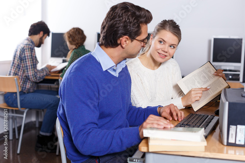 Couple of students studying in computer class