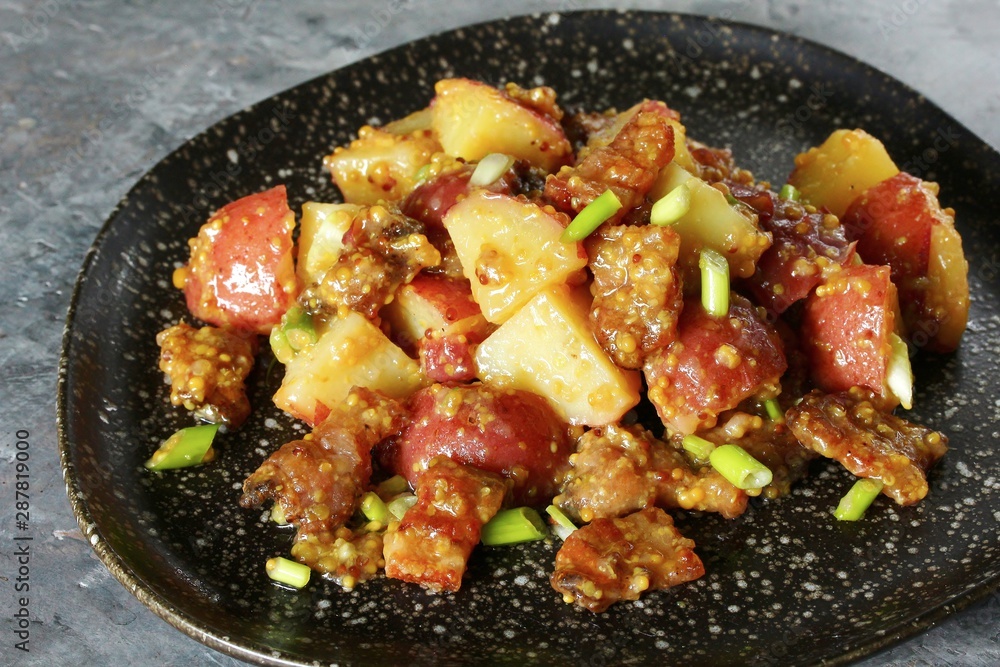 German potato salad with fried bacon and mustard dressing. traditional for oktoberfest festival. German potato salad with fried bacon and mustard dressing. traditional for oktoberfest festival.