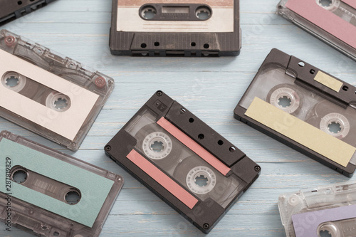 Old plastic cassette on wooden background. Retro music concept