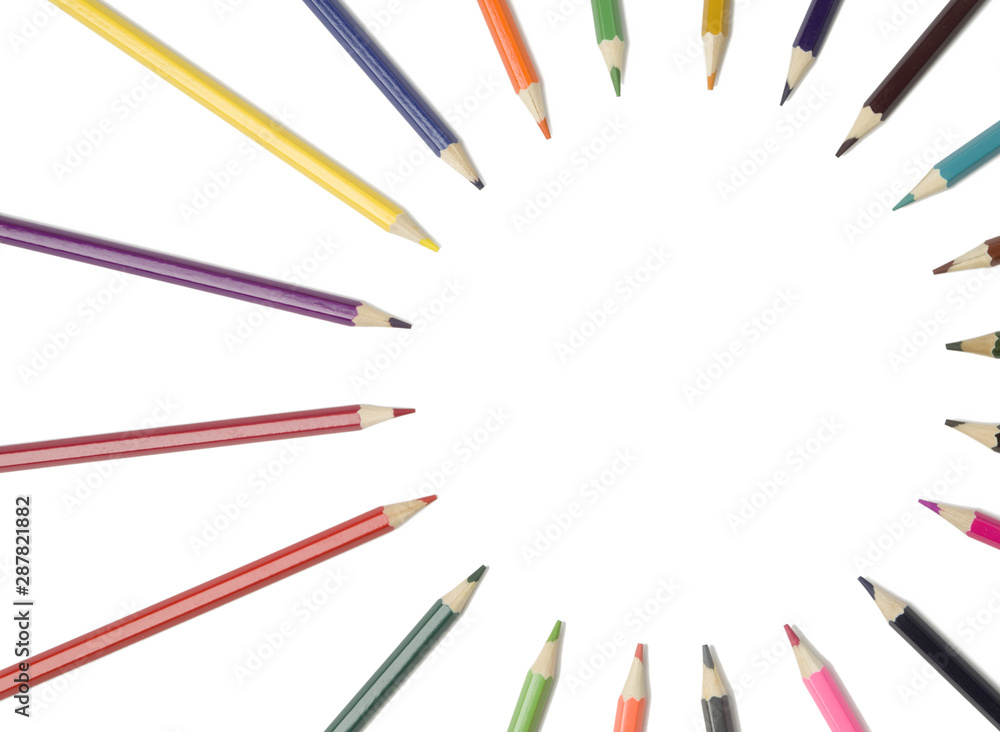  colored pencils lie in a circle on an isolated white background. Copy space.