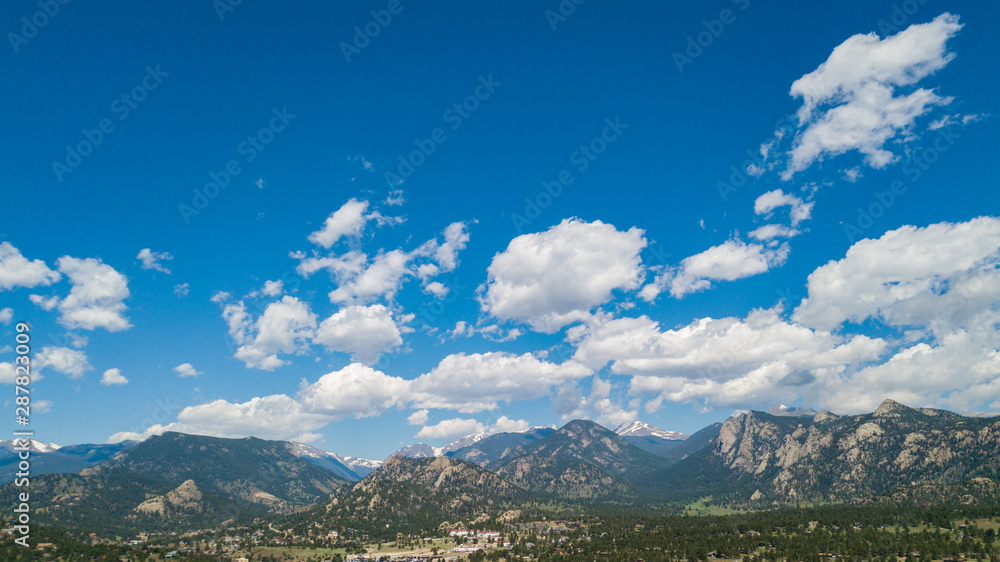 White Fluffy Clouds in Mountain Range of Colorado