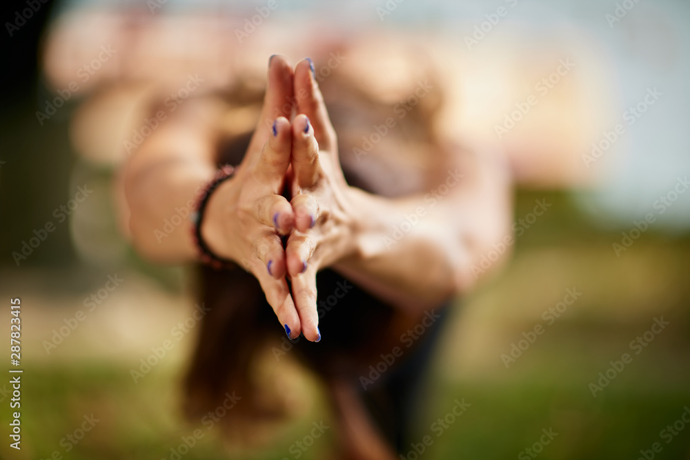 Iyengar yoga balance. Fit caucasian woman in purple leggings