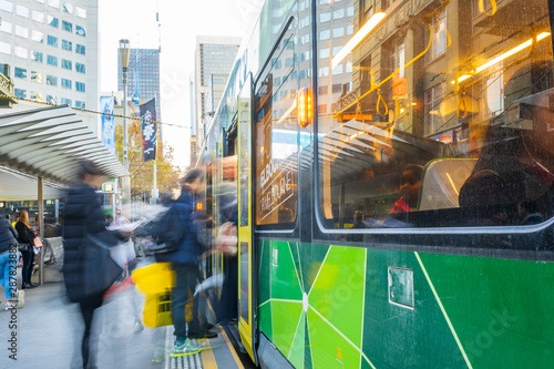 Commuters rushing to board public transport in city street