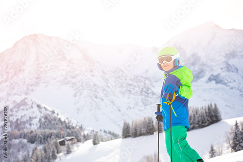 Portrait of a boy in ski clothes over mountain