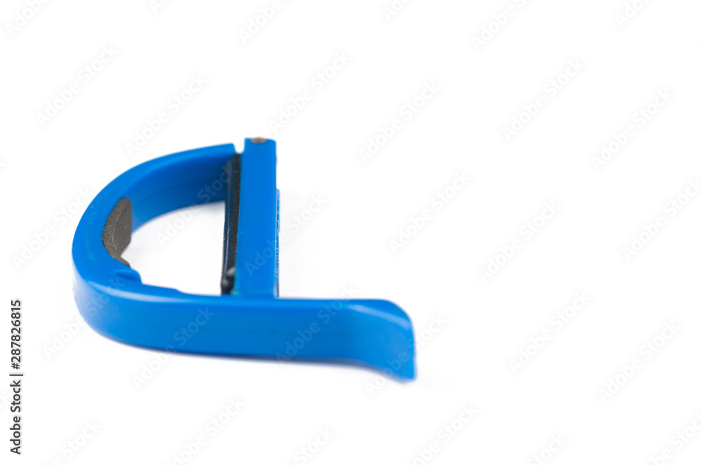 Blue guitar capo isolated on white background.Copy space Blue guitar capo isolated on white background.Copy space