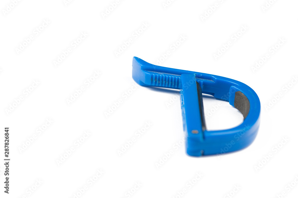 Blue guitar capo isolated on white background.Copy space Blue guitar capo isolated on white background.Copy space