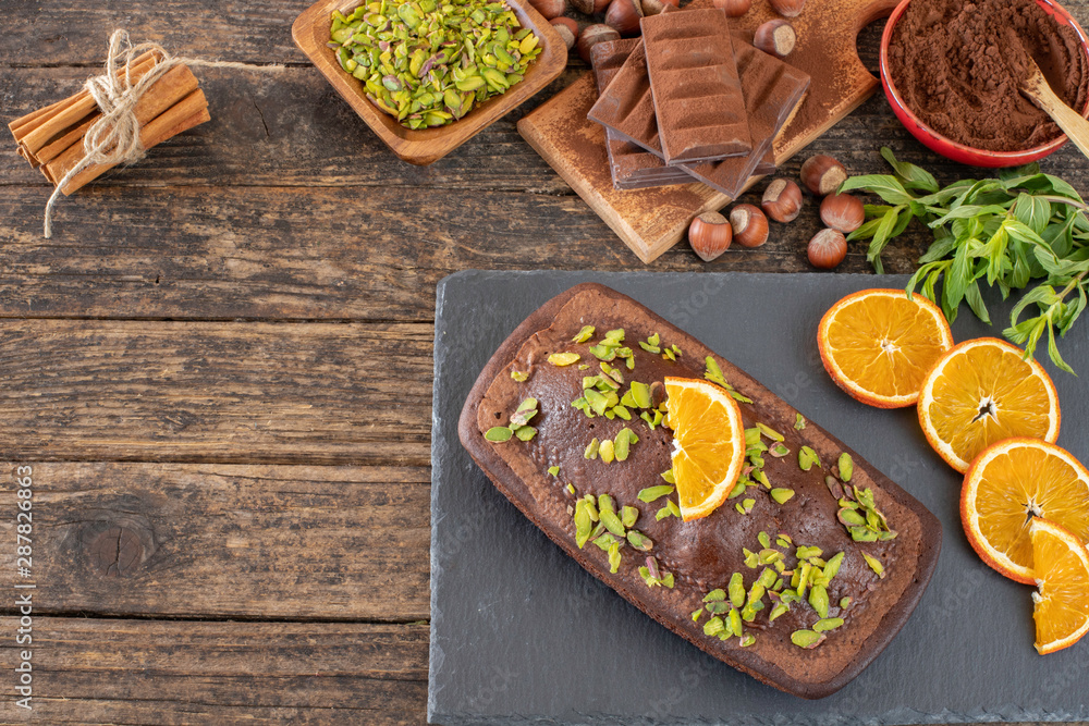 Cake with chocolate , cocoa , flour and hazelnut on the wooden table