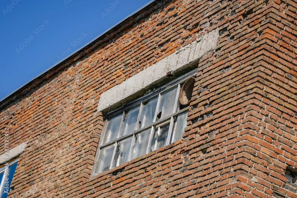 Broken Windows on a brick wall. close-up Broken Windows on a brick wall. close-up