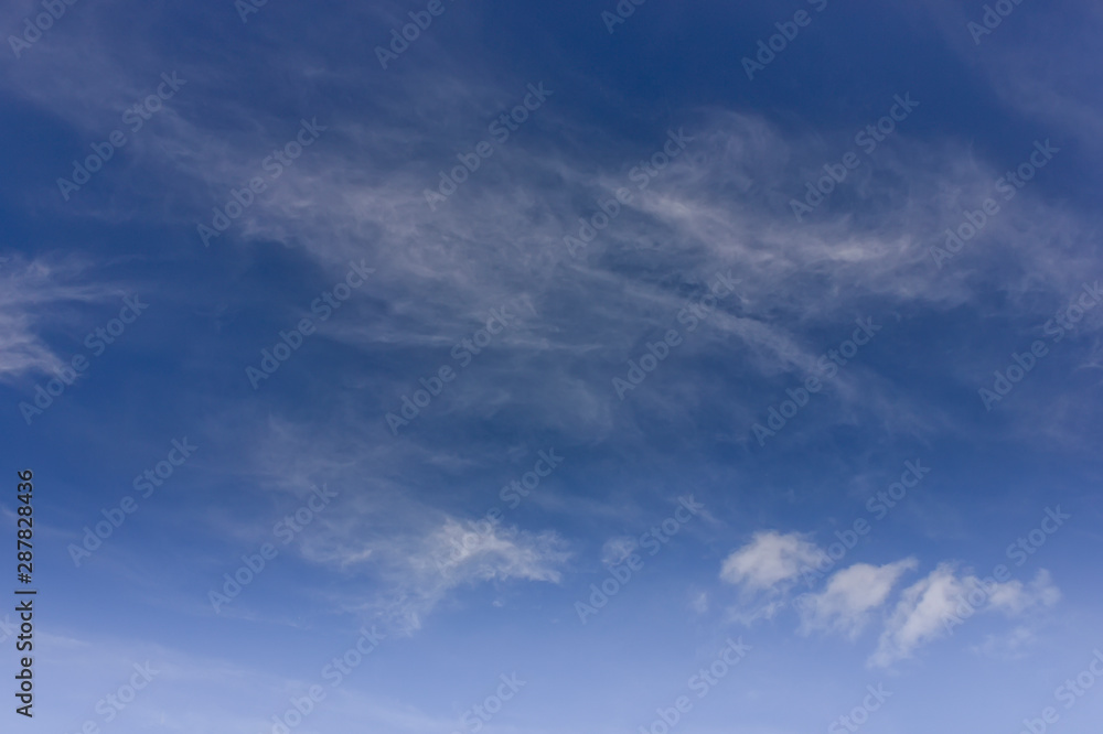 Blue summer sky and light white clouds. Blue sky background with clouds.