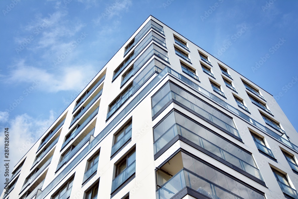 Fototapeta premium Modern and new apartment building. Multistoried modern, new and stylish living block of flats.