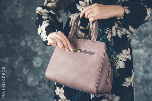 young woman hand bag on abstract background © ARAMYAN