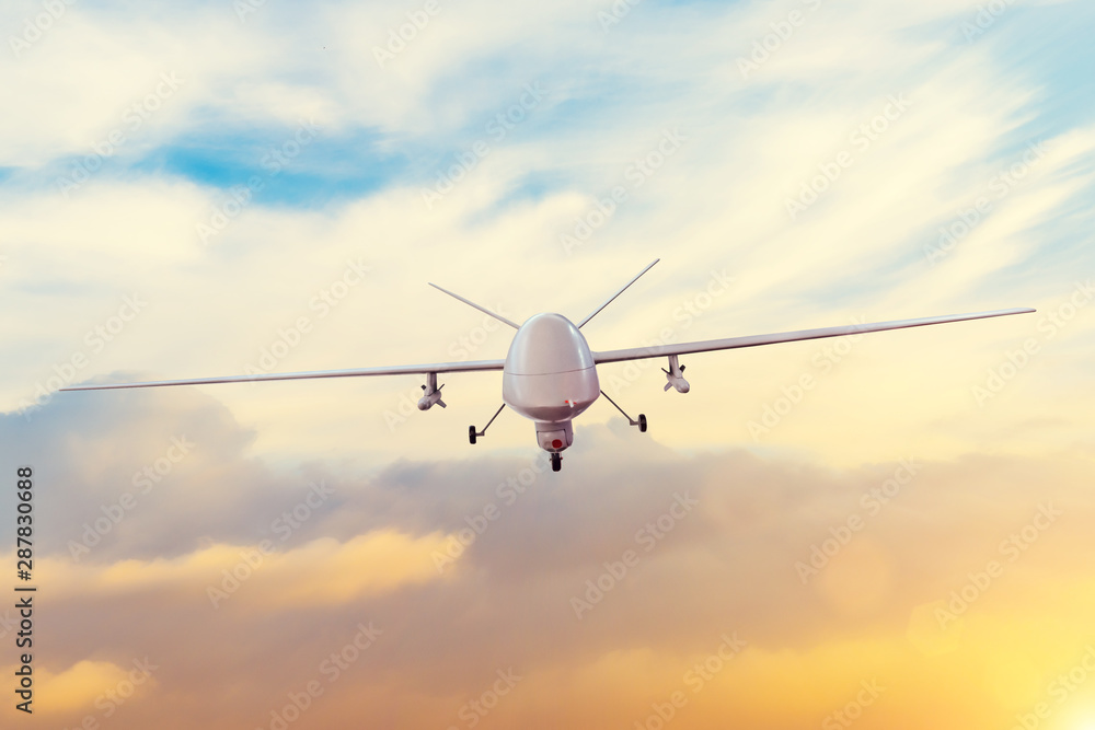 Unmanned military drone patrols the territory at sunset. The view is straight ahead. - obrazy, fototapety, plakaty 