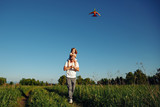 A father and child on meadow with a kite in the summer