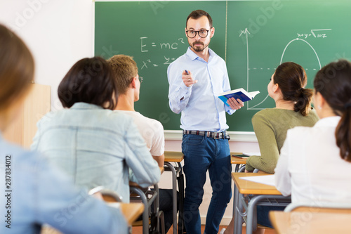 Man teacher giving lecture in classroom