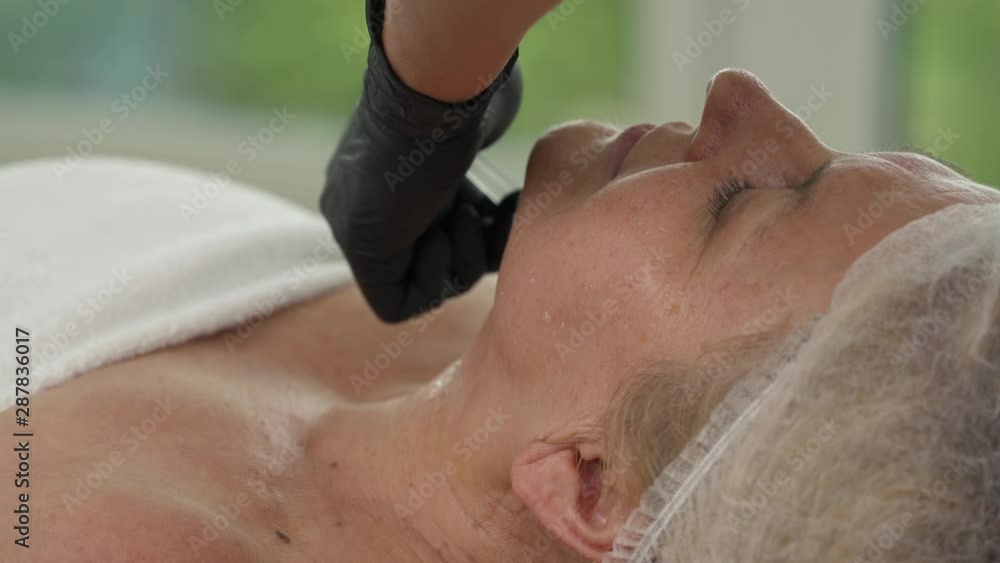 Close-up view of a sophisticated therapist doing anti aging injections to senior female patient. Antiaging and aesthetic treatment. Mesotherapy Close-up view of a sophisticated therapist doing anti aging injections to senior female patient. Antiaging and aesthetic treatment. Mesotherapy