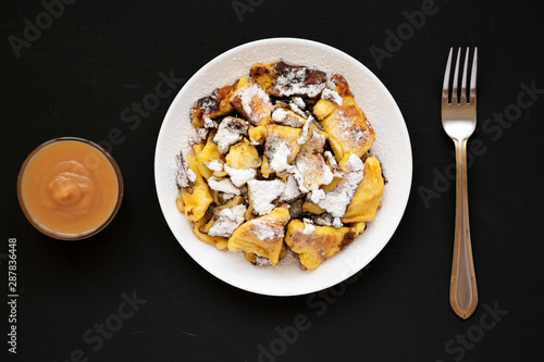 Homemade german Kaiserschmarrn pancake on a black background, top view. Flat lay, overhead, from above.