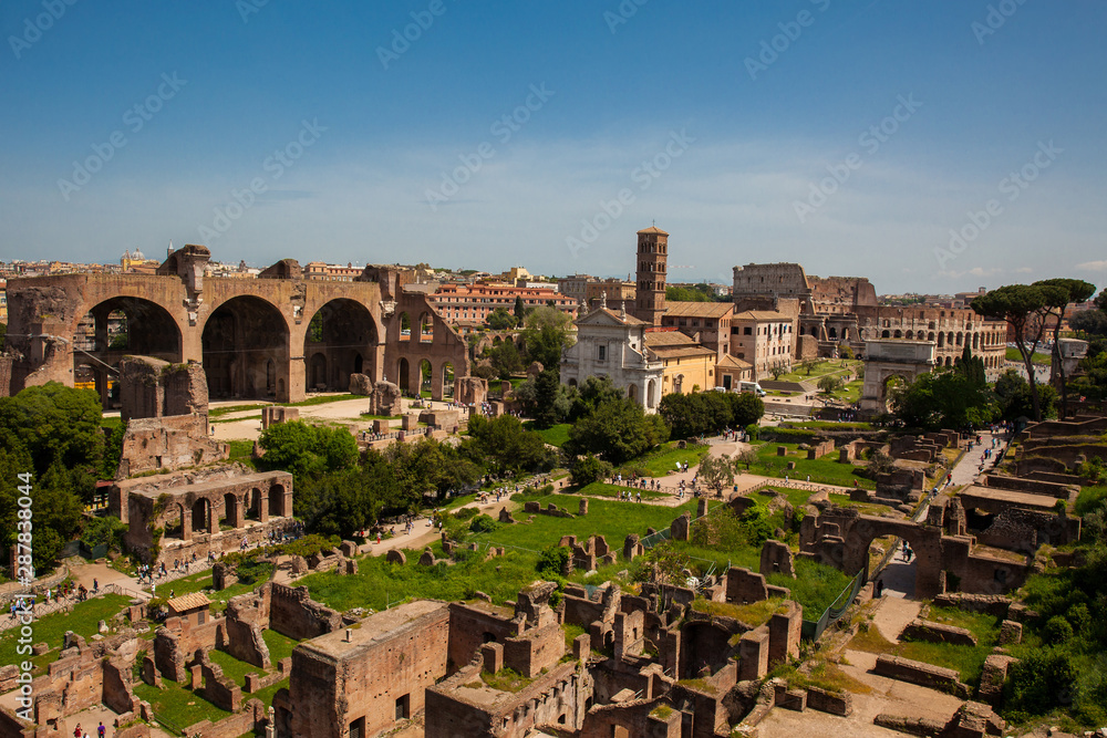 View of the ancient ruins of the Roman Forum and the Colosseum in Rome