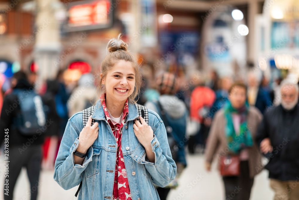 Portrait of happy young woman at the train station Portrait of happy young woman at the train station