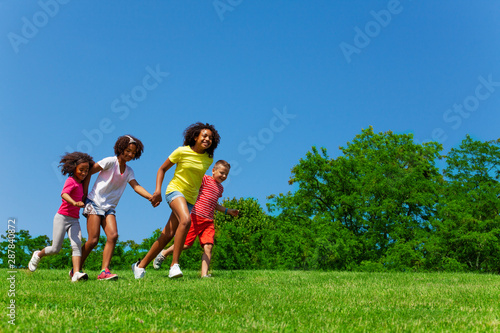 Side view of running children group in the park © Sergey Novikov