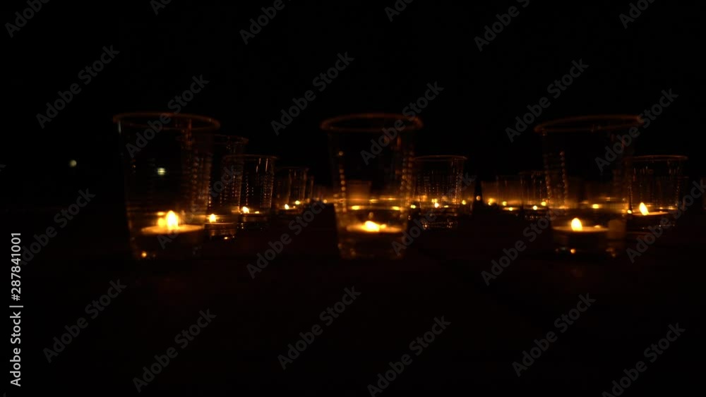 burning candles in Glasses A Lot At Night On Street Street Bridge Under the Open Sky In Memory of Holiday Earth Day burning candles in Glasses A Lot At Night On Street Street Bridge Under the Open Sky In Memory of Holiday Earth Day