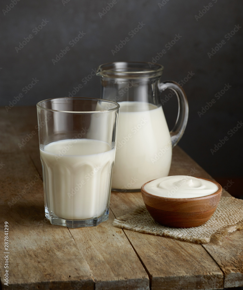 milk and sour cream on wooden table milk and sour cream on wooden table