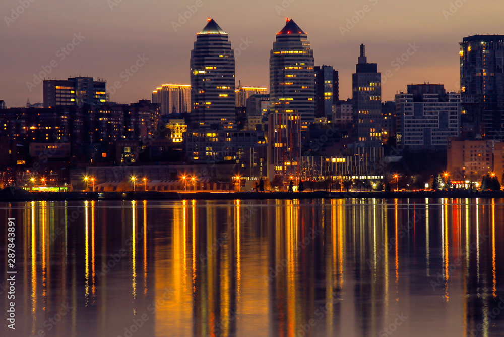 Night big city. Beautiful high buildings, skyscrapers and towers on the River Dnipro city, Dnepropetrovsk, Ukraine, spring, autumn, summer