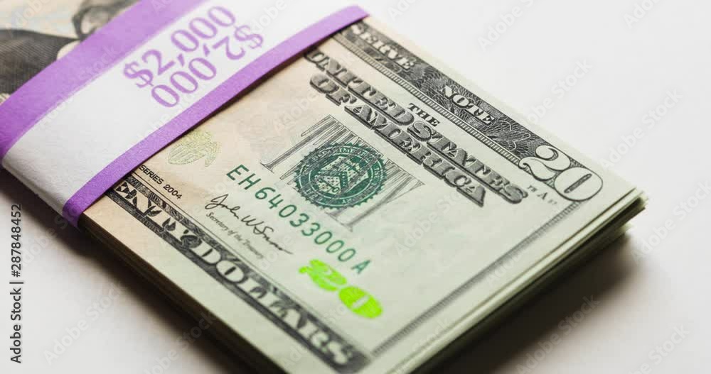Wrapped US Money Thrown Down On White Background Wrapped US Money Thrown Down On White Background