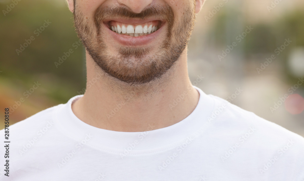Close up portrait of handsome man with beard smiling outside. Close up portrait of handsome man with beard smiling outside.
